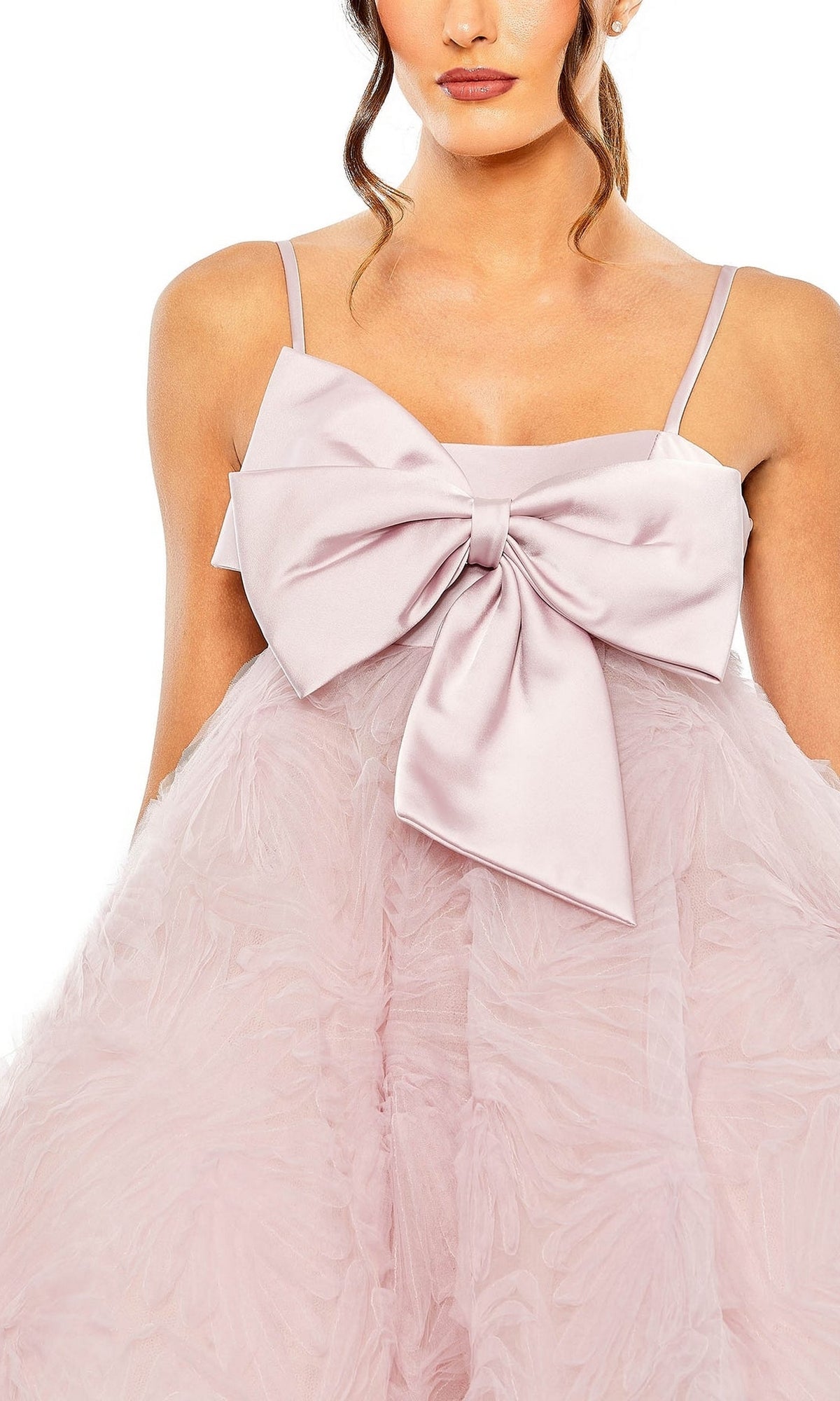 Model wears the Short Homecoming Dress 20583 by Mac Duggal in rose pink, featuring a large chest bow and textured feathery fabric, shown from shoulders to mid-thigh.